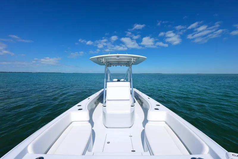 Slide: The Image of 2026 Contender 29 Bay boat on open water under clear blue sky. - 7