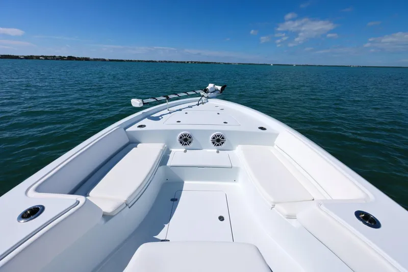 Slide: The Image of 2026 Contender 29 Bay boat on calm blue water under clear sky. - 8