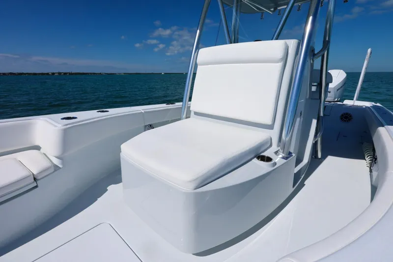 Slide: The Image of 2026 Contender 29 Bay boat interior with white seating, ocean backdrop. - 9