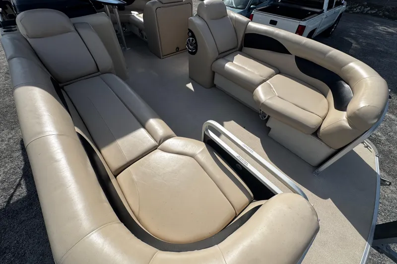 Slide: The Image of 2015 AquaPatio 250 WB boat interior with beige leather seating and spacious layout. - 3
