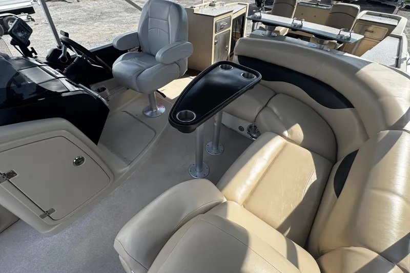 Slide: The Image of Interior of 2015 AquaPatio 250 WB boat with beige seating and black table. - 4