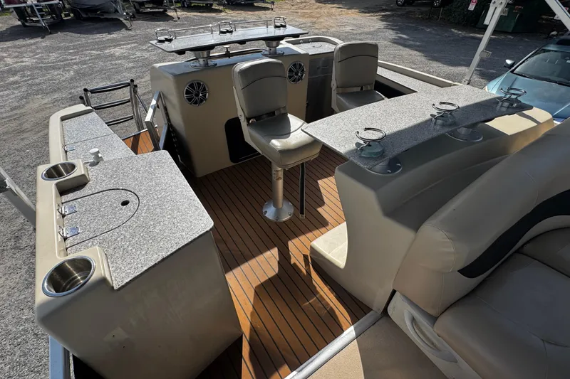 Slide: The Image of Interior of a 2015 AquaPatio 250 WB boat with seating and countertops. - 6