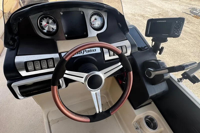 Slide: The Image of Dashboard of a 2015 AquaPatio 250 WB boat with steering wheel and controls. - 8