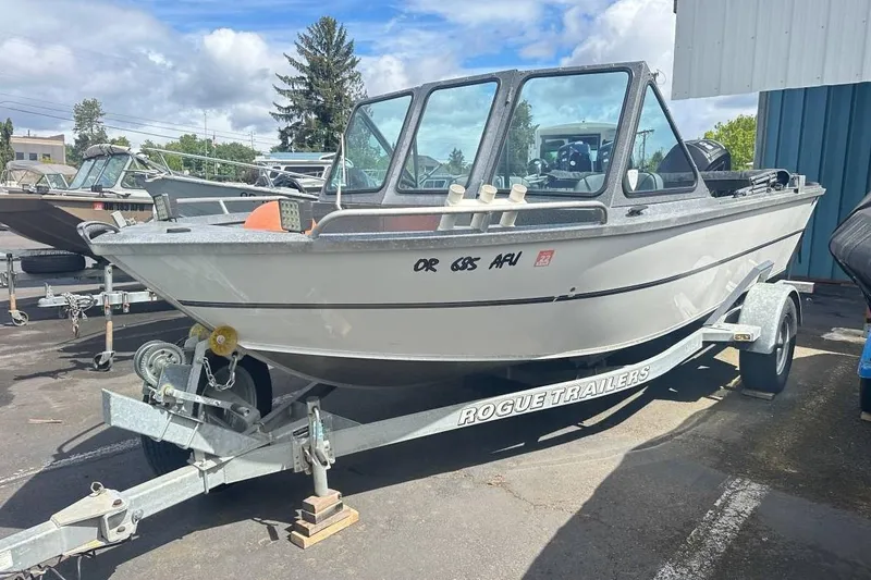 The Image of 2017 Alumaweld Stryker 18 boat on Rogue trailer, parked outdoors. - 1