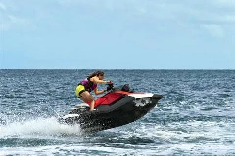 Slide: The Image of 2024 Sea-Doo Spark Trixx jet ski performing tricks on the ocean. - 3
