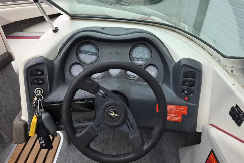 Slide: The Image of 1993 Searay 200 boat dashboard with steering wheel and instrument gauges. - 10