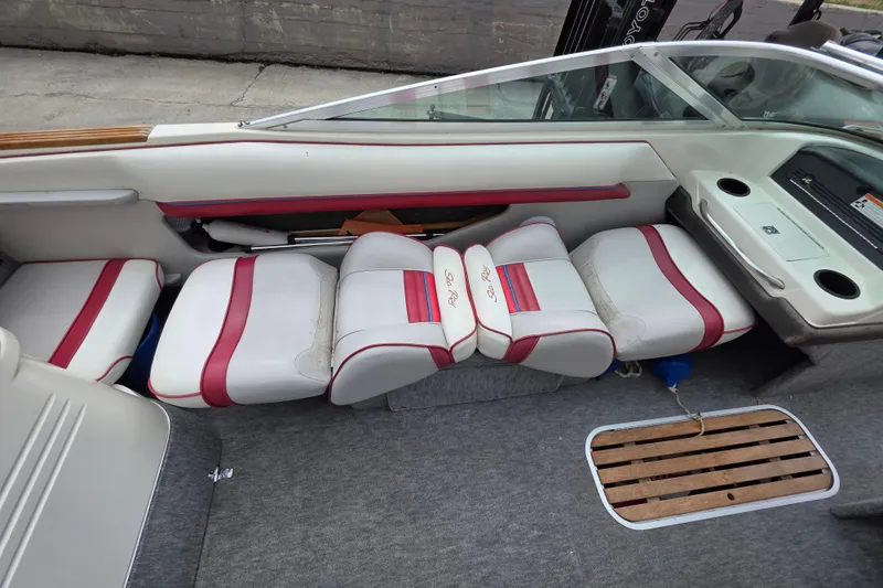Slide: The Image of Interior of a 1993 Searay 200 boat with red and white seating. - 11
