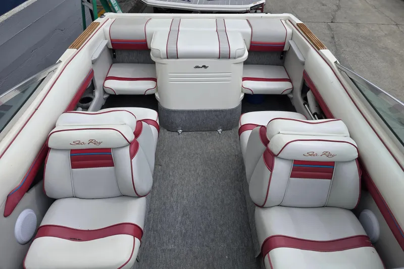 Slide: The Image of Interior of a 1993 Searay 200 boat with white and red seating. - 6