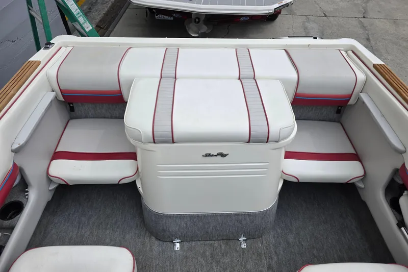Slide: The Image of Interior of a 1993 Searay 200 boat with white and red seating. - 7