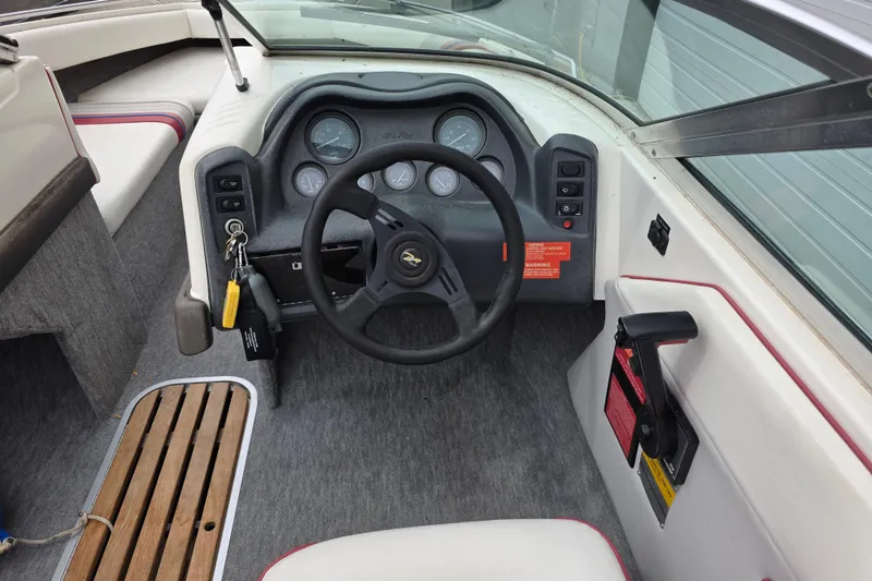 Slide: The Image of Interior view of a 1993 Searay 200 boat cockpit with steering wheel and controls. - 9