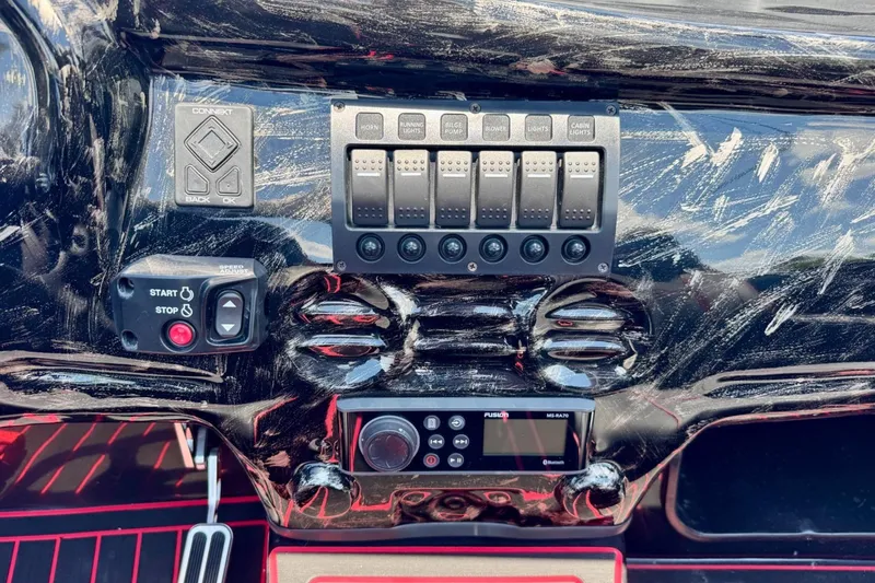 Slide: The Image of Dashboard of 2025 Watersports Car Series R with control switches and start-stop button. - 12