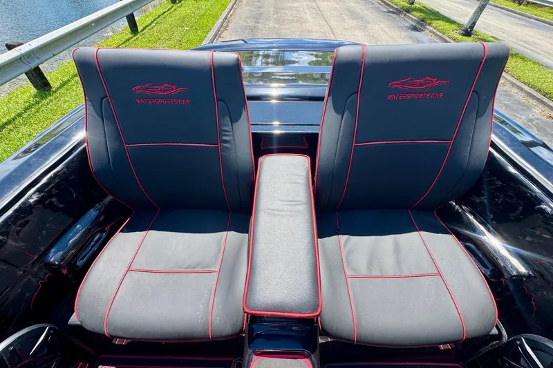 Slide: The Image of 2025 Watersports Car Series R seats with red stitching, parked by a lakeside road. - 13