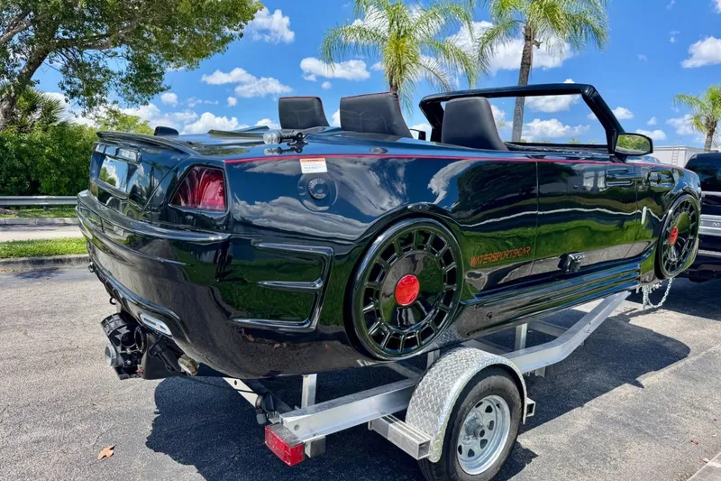 Slide: The Image of 2025 Watersports Car Series R on trailer, convertible design, palm trees in background. - 5