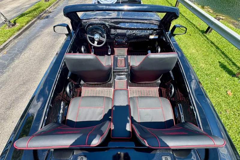 Slide: The Image of Convertible Watersports Car Series R 2025 interior with black and red seats, top-down view. - 9