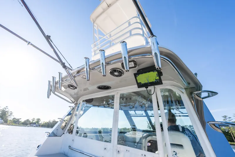 Slide: The Image of 2011 Everglades 350EX boat with fishing rods and navigation system on a sunny day. - 10