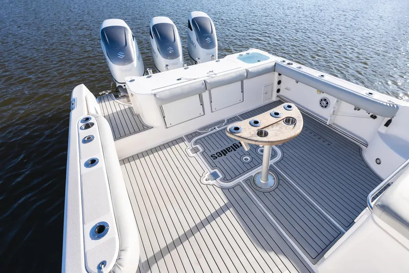 Slide: The Image of 2011 Everglades 350EX boat deck with triple outboard engines on calm water. - 11