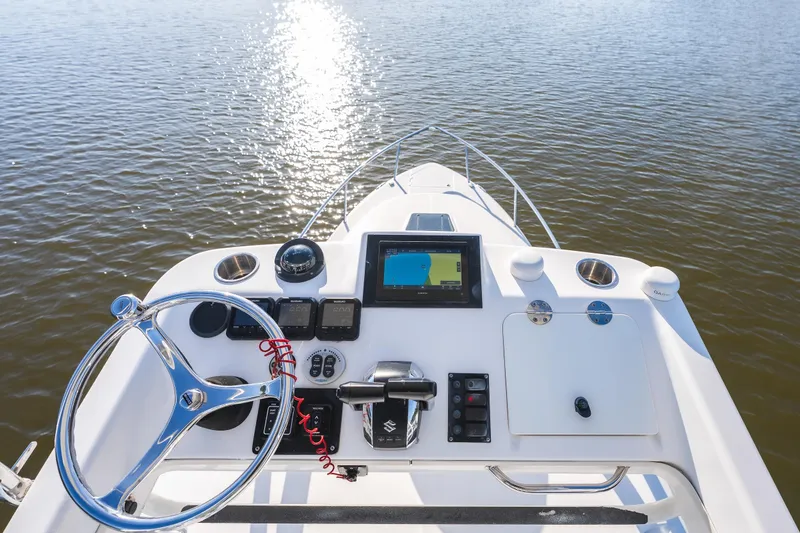 Slide: The Image of Cockpit view of 2011 Everglades 350EX boat with navigation equipment on calm water. - 15