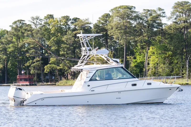 Slide: The Image of 2011 Everglades 350EX boat on a serene lake. - 2