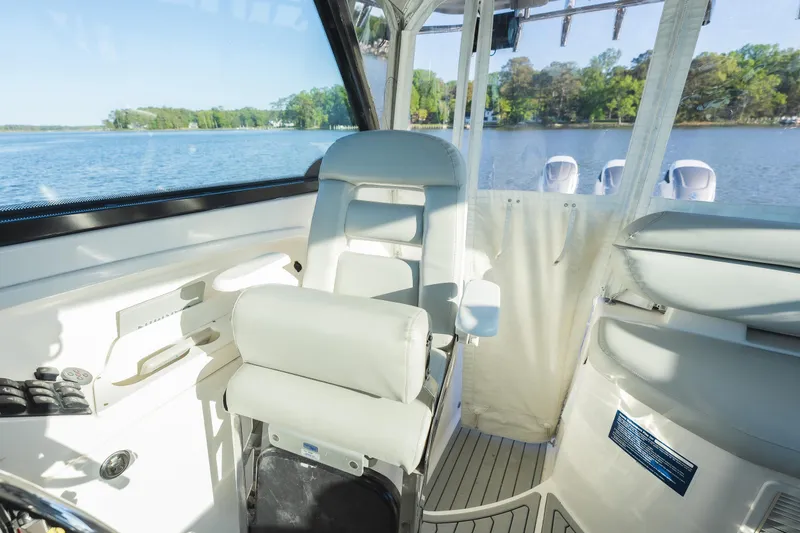 Slide: The Image of Luxurious interior of 2011 Everglades 350EX boat with comfortable seating and scenic lake view. - 8