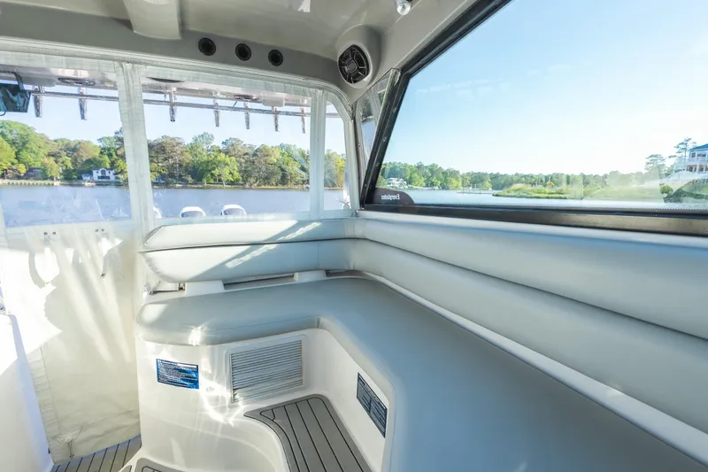 Slide: The Image of Interior view of 2011 Everglades 350EX boat with cushioned seating and scenic water backdrop. - 9