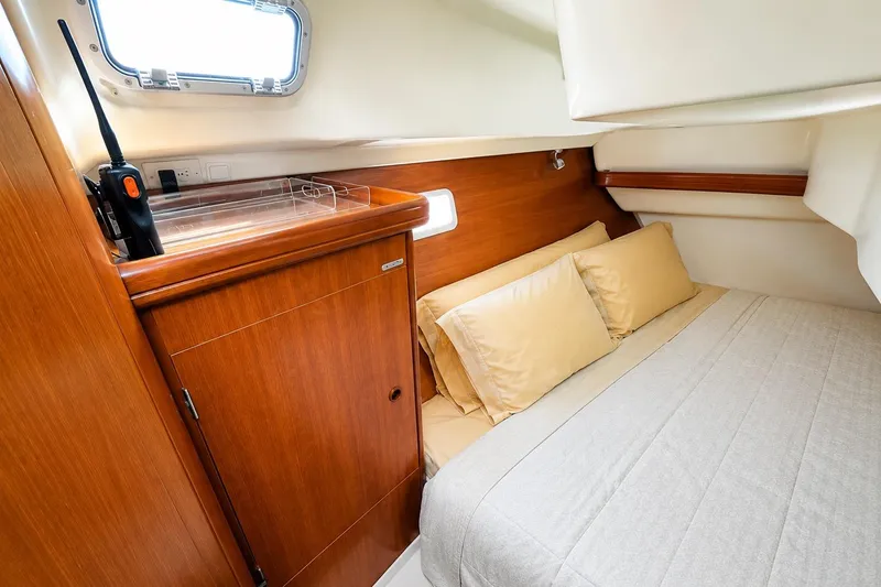 Slide: The Image of Cozy cabin interior of 2001 Beneteau 361 yacht with wooden cabinetry and comfortable bedding. - 14