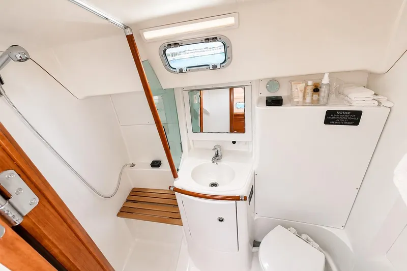 Slide: The Image of Bathroom interior of 2001 Beneteau 361 yacht, featuring sink, shower, and storage. - 15