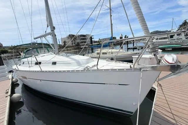 Slide: The Image of 2001 Beneteau 361 sailboat docked at marina, showcasing sleek design and white hull. - 3