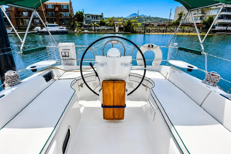 Slide: The Image of Cockpit of 2001 Beneteau 361 sailboat with scenic waterfront view. - 6
