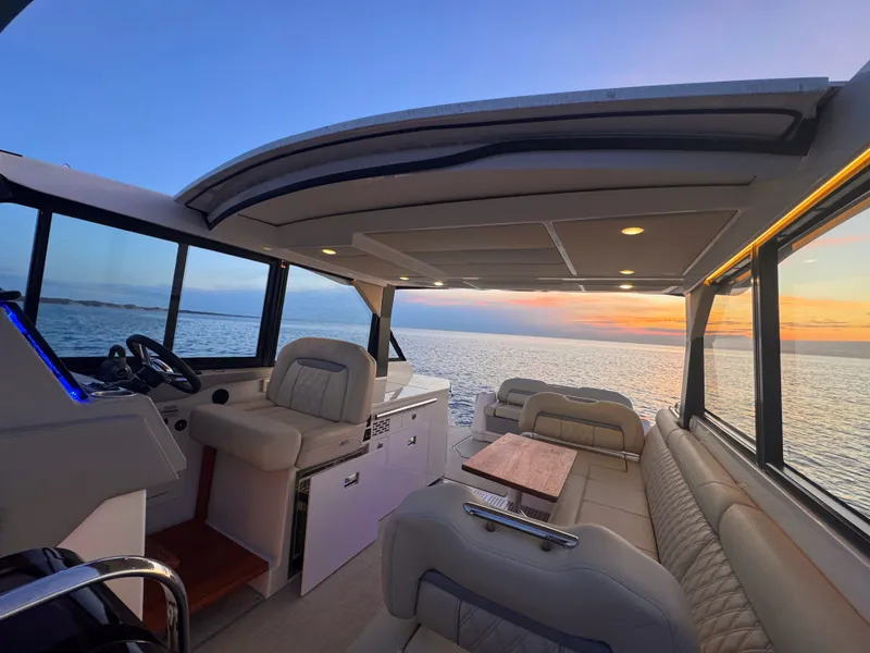 Slide: The Image of Interior of 2022 Regal 36 Grand Coupe at sunset on the sea. - 6