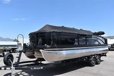 Slide: The Image of 2026 Lowe SF 232 Sport Fish pontoon boat on trailer, covered and ready for transport. - 1
