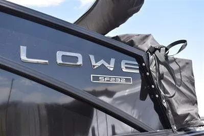 Slide: The Image of 2026 Lowe SF 232 Sport Fish boat with sleek black exterior and logo detail. - 12