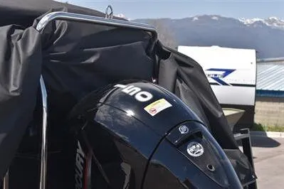 Slide: The Image of 2026 Lowe SF 232 Sport Fish boat with Mercury outboard motor, mountain backdrop. - 13