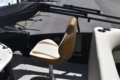 Slide: The Image of 2026 Lowe SF 232 Sport Fish boat interior with tan seating and fishing rod holders. - 25