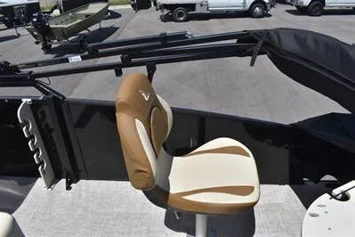 Slide: The Image of 2026 Lowe SF 232 Sport Fish boat seat, tan and cream upholstery, outdoor setting. - 26