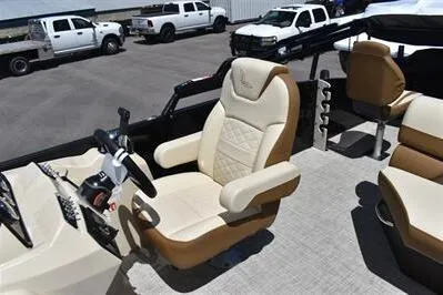 Slide: The Image of 2026 Lowe SF 232 Sport Fish boat interior with beige captain's chair and steering console. - 29