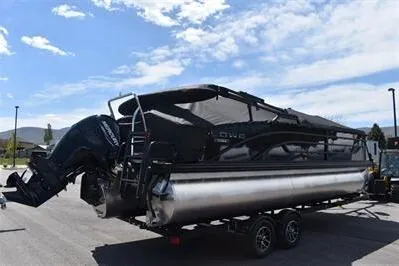 Slide: The Image of 2026 Lowe SF 232 Sport Fish pontoon boat on trailer under a clear sky. - 3