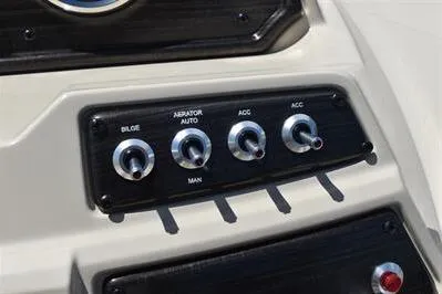 Slide: The Image of Control panel of 2026 Lowe SF 232 Sport Fish boat with switches for bilge and accessories. - 34