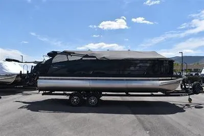 Slide: The Image of 2026 Lowe SF 232 Sport Fish pontoon boat on trailer under clear blue sky. - 4