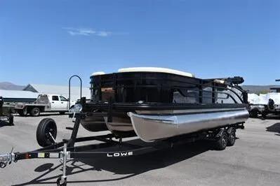 Slide: The Image of 2026 Lowe SF 232 Sport Fish pontoon boat on trailer under clear blue sky. - 6