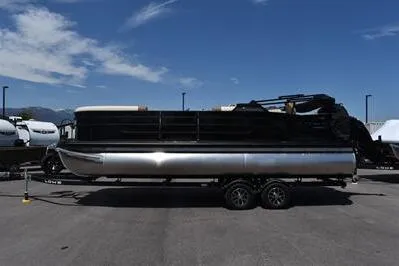 Slide: The Image of 2026 Lowe SF 232 Sport Fish pontoon boat on trailer under clear blue sky. - 7