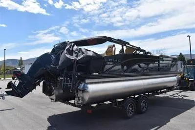 Slide: The Image of 2026 Lowe SF 232 Sport Fish pontoon boat on trailer under clear sky. - 9