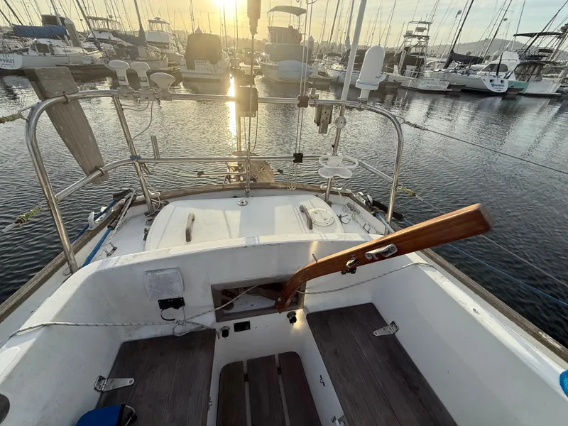 Slide: The Image of Cockpit of a 1980 Rival 32 sailboat in harbor at sunset. - 11