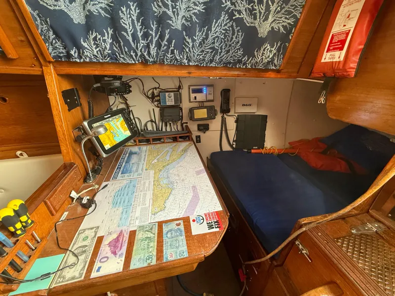 Slide: The Image of Navigation area of a 1980 Rival 32 yacht with maps and equipment. - 16