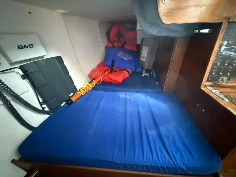 Slide: The Image of Interior of a 1980 Rival 32 sailboat with blue mattress. - 17