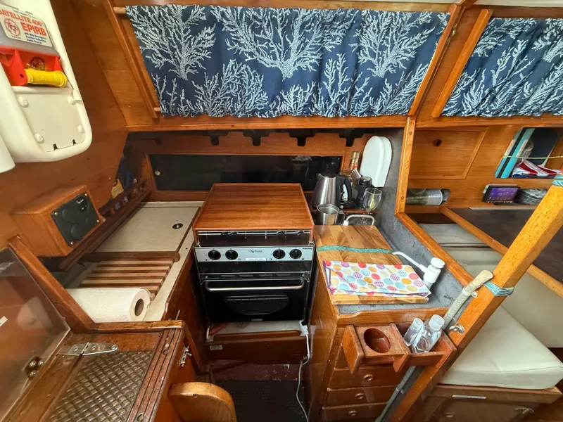 Slide: The Image of Interior of a 1980 Rival 32 yacht featuring a kitchen. - 18