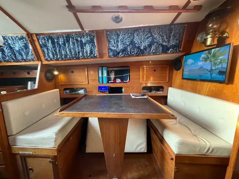 Slide: The Image of Interior of a 1980 Rival 32 yacht with cozy seating area. - 19