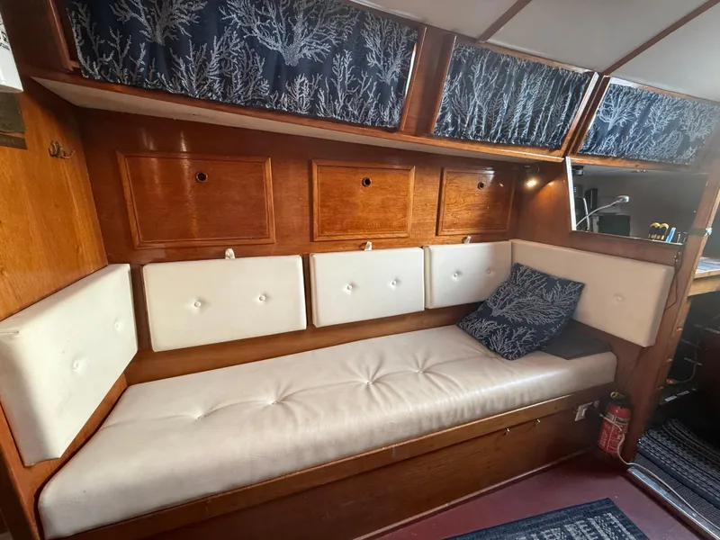 Slide: The Image of Interior of a 1980 Rival 32 yacht with cozy seating area. - 20