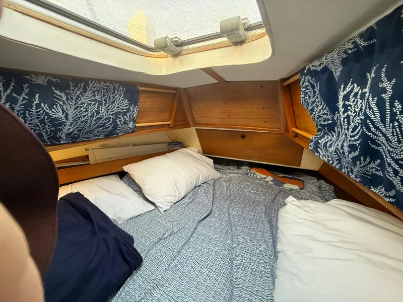 Slide: The Image of Interior of a 1980 Rival 32 yacht with cozy bedding. - 21