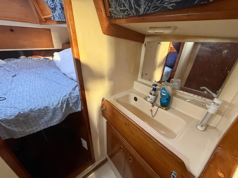 Slide: The Image of Interior of a 1980 Rival 32 yacht with sink and sleeping area. - 23