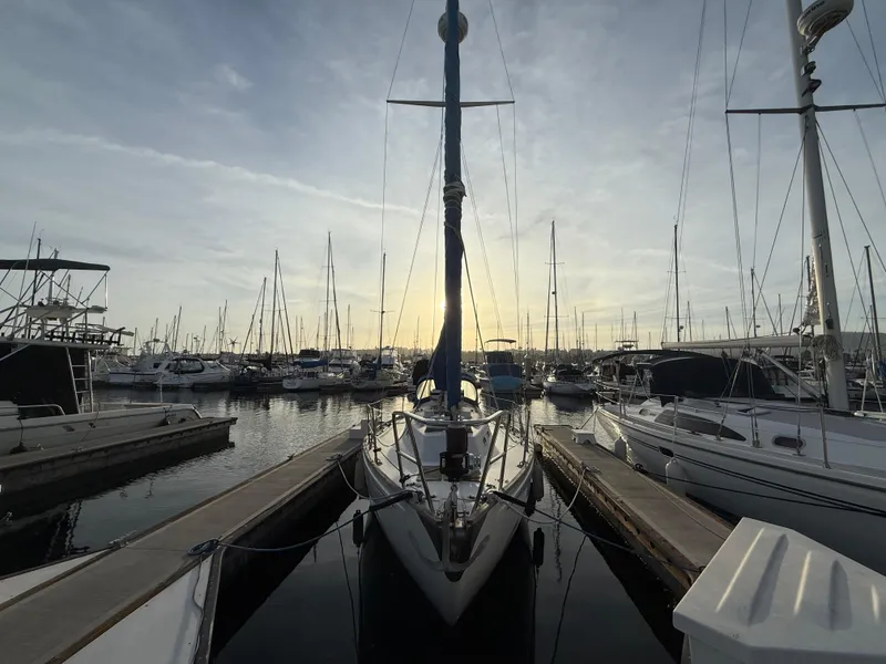 Slide: The Image of 1980 Rival 32 sailboat docked at sunset in marina. - 5